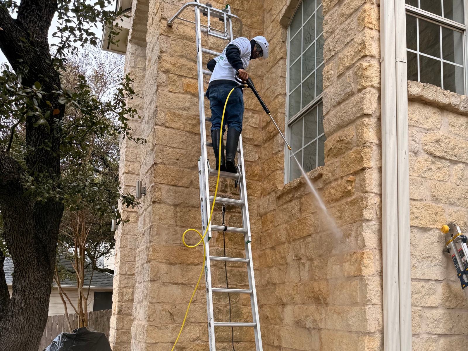 Pressure washing a limestone home